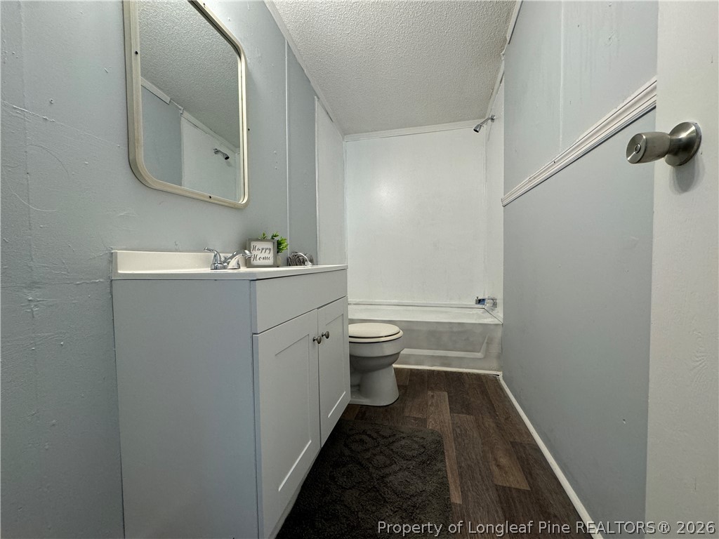 511 Inverary Drive Raeford, NC 28376 - Photo 25 of 32 a bathroom with a sink and mirror with toilet