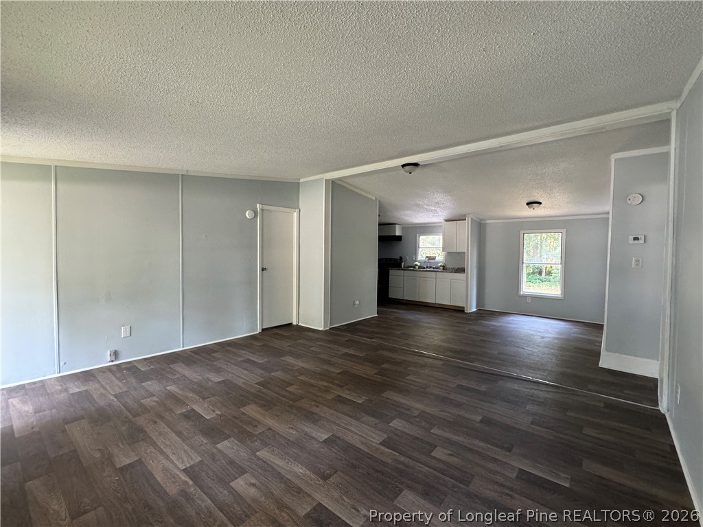 511 Inverary Drive Raeford, NC 28376 - Photo 7 of 32 a view of an empty room with window and wooden floor