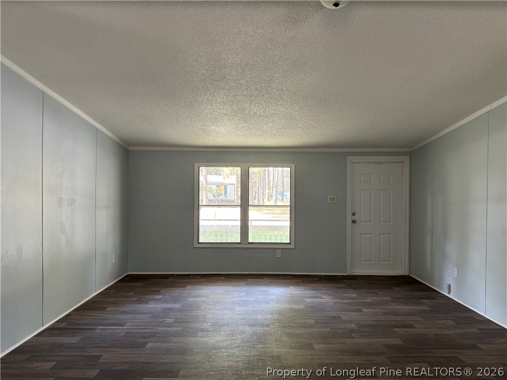 511 Inverary Drive Raeford, NC 28376 - Photo 8 of 32 an empty room with wooden floor and windows