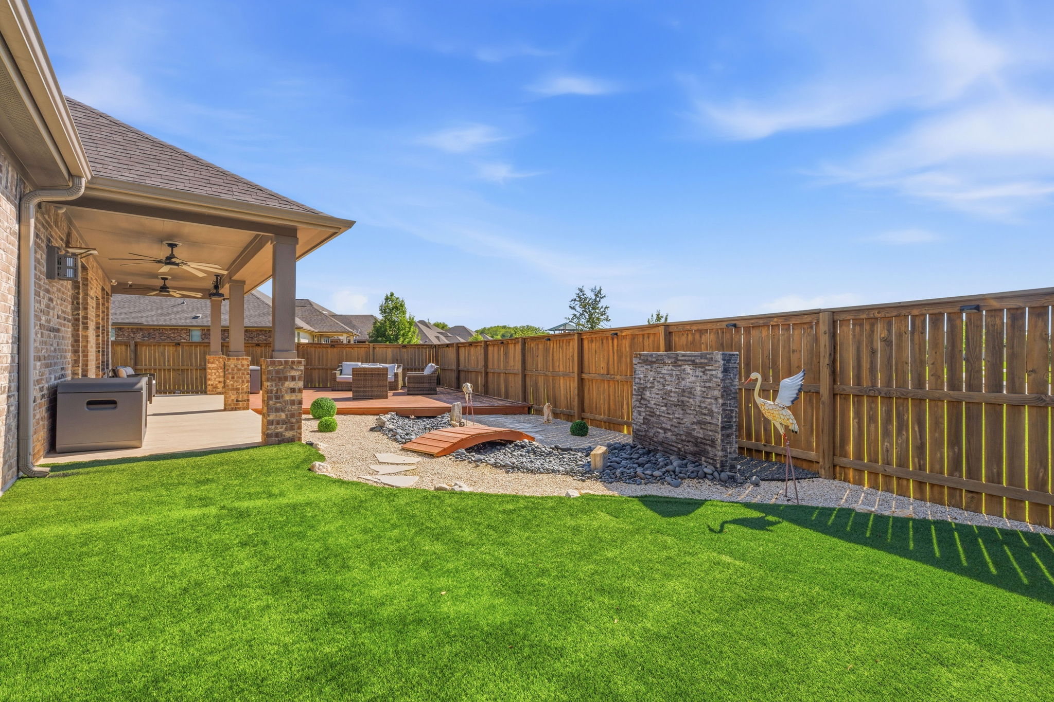 12616 Twisted Root Drive Manchaca, TX 78652 - Photo 28 of 36 The real magic starts out back with a covered patio, decks and custom landscaping including a Zen rock waterfall feature.