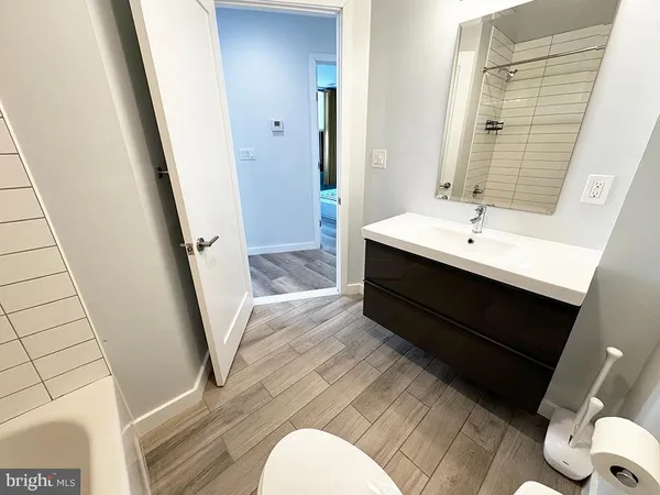 a white toilet sitting next to a bathroom sink