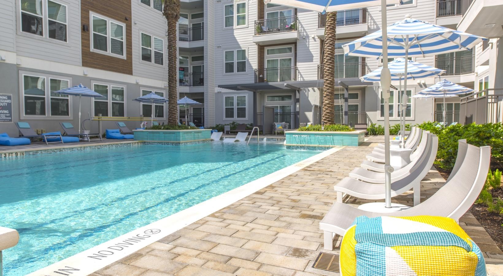 9330 South Main Street, Unit 424 Houston, TX 77025 - Photo 23 of 24 a view of a swimming pool with a lounge chairs in a patio
