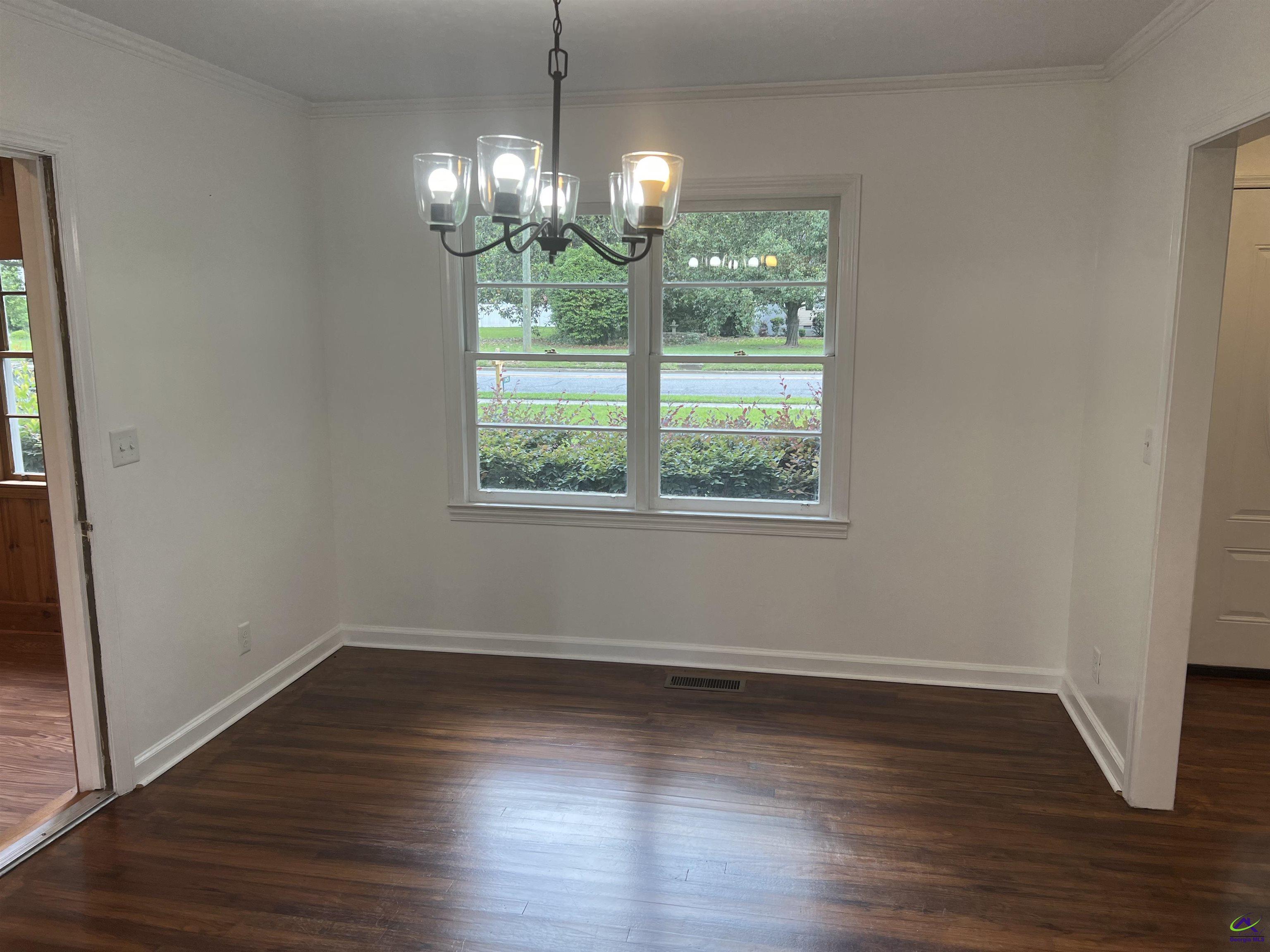 145 South 2nd Street Cochran, GA 31014 - Photo 10 of 24 a view of a room with wooden floor and chandelier