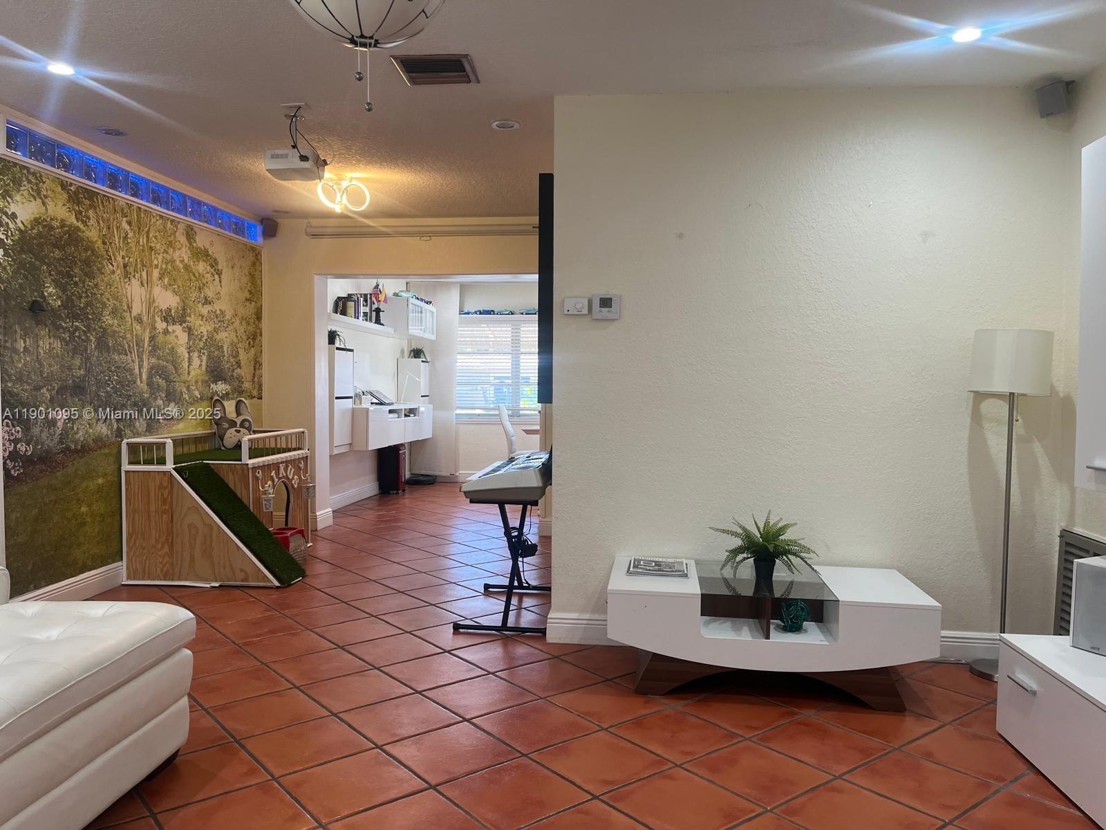 4913 Northwest 47th Avenue, Unit 4913 Tamarac, FL 33319 - Photo 3 of 7 a living room with furniture a table and a potted plant