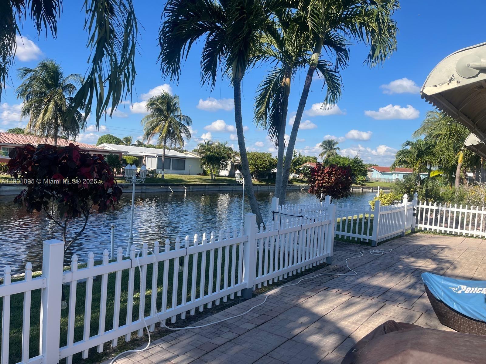 4913 Northwest 47th Avenue, Unit 4913 Tamarac, FL 33319 - Photo 6 of 7 a view of swimming pool with a table and chairs