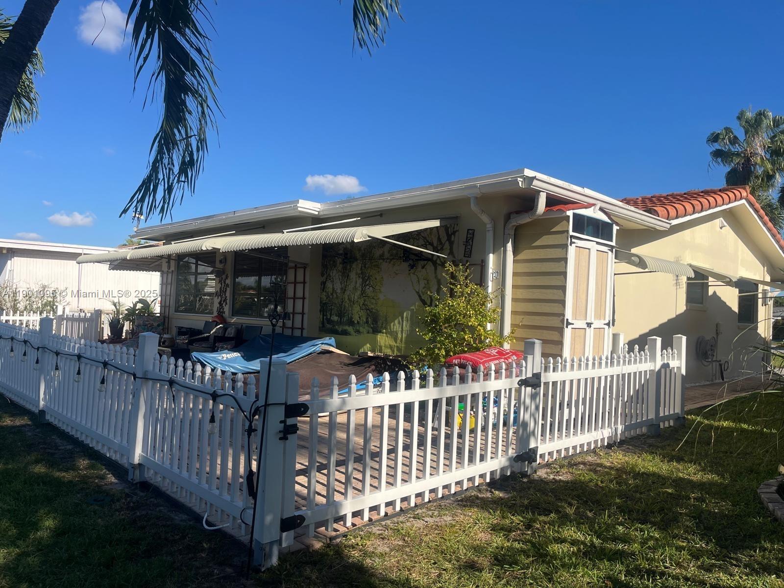 4913 Northwest 47th Avenue, Unit 4913 Tamarac, FL 33319 - Photo 7 of 7 a front view of a house having yard
