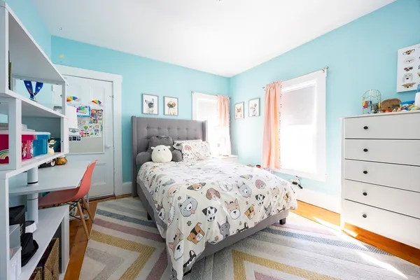a bedroom with a bed and a dresser in it