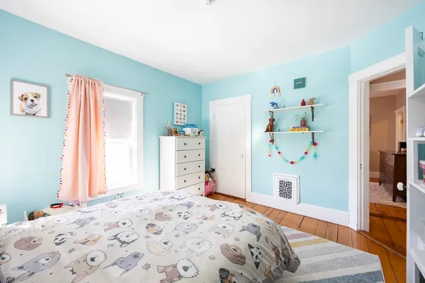 a bedroom with a bed and a dresser in it