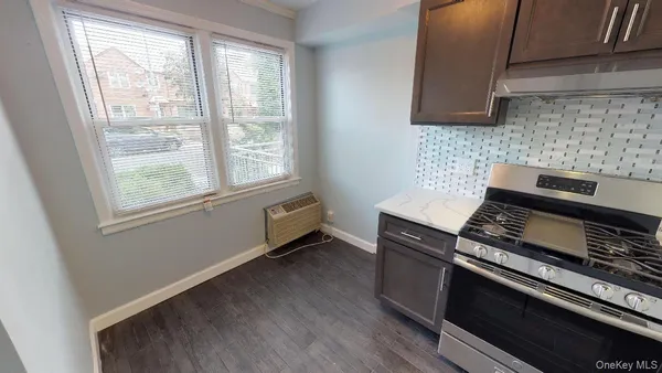 a kitchen with wooden cabinets and a stove top oven