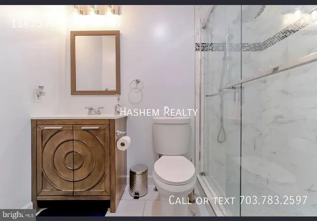 a bathroom with a toilet a sink and a mirror