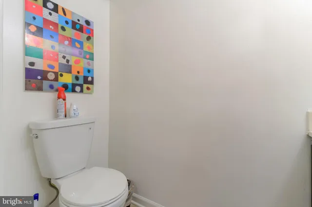 a white toilet sitting next to a sink