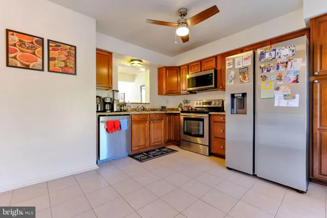 a kitchen with stainless steel appliances a stove top oven a sink and a refrigerator
