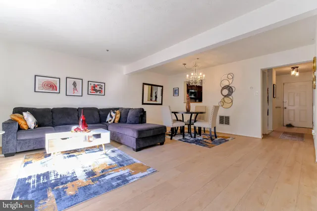 a living room with furniture and kitchen view