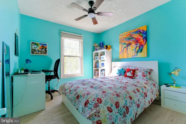 a bedroom with a bed and a bookshelf