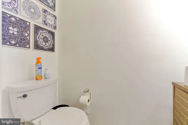 a white toilet sitting next to a bathroom sink