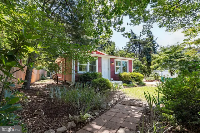 a view of house with yard and sitting area