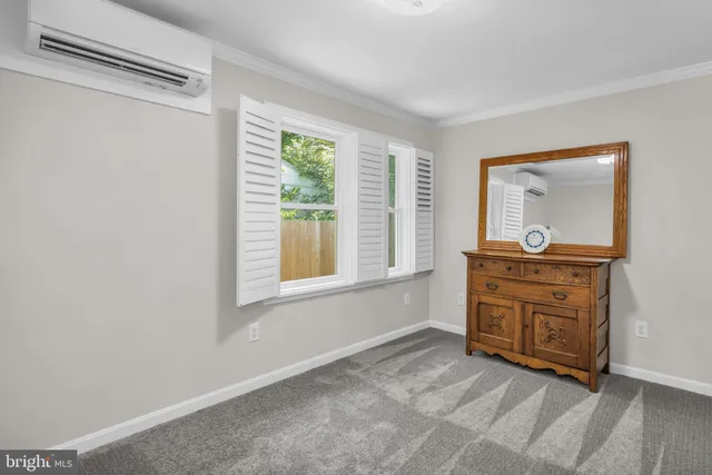 a room with a dresser and a window