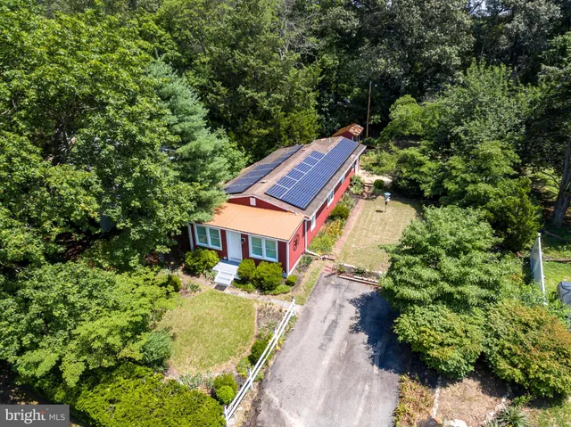 a view of house with yard and green space