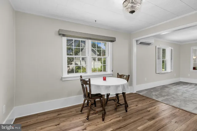 a view of a dining room with a table and chairs