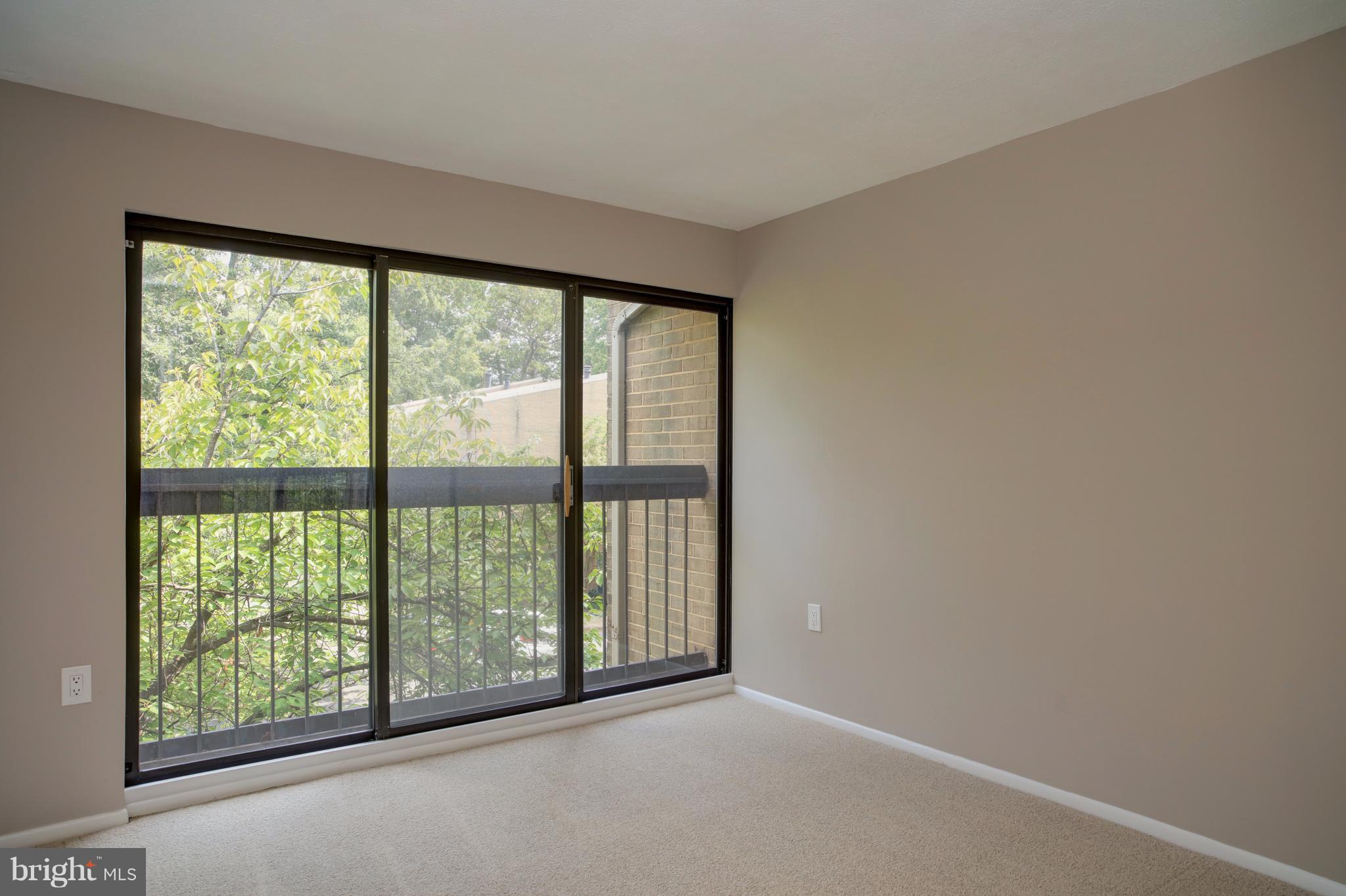 11616 Ivystone Court, Unit 301 Reston, VA 20191 - Photo 14 of 29 a view of an empty room with wooden floor and a window