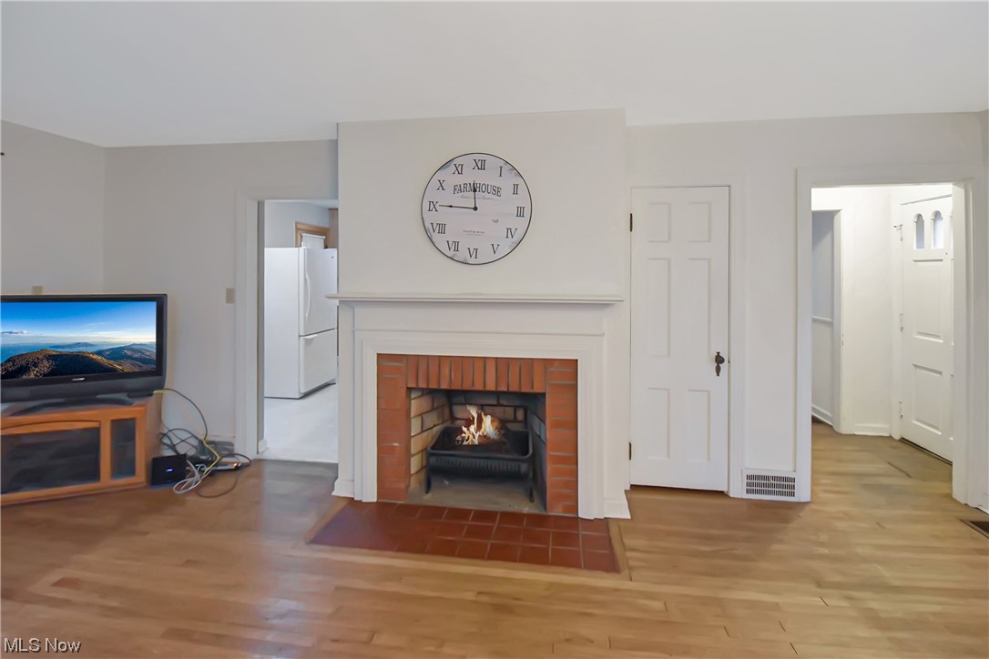 1068 Rushleigh Road Cleveland Heights, OH 44121 - Photo 3 of 22 Living room featuring light wood-type flooring and a brick fireplace