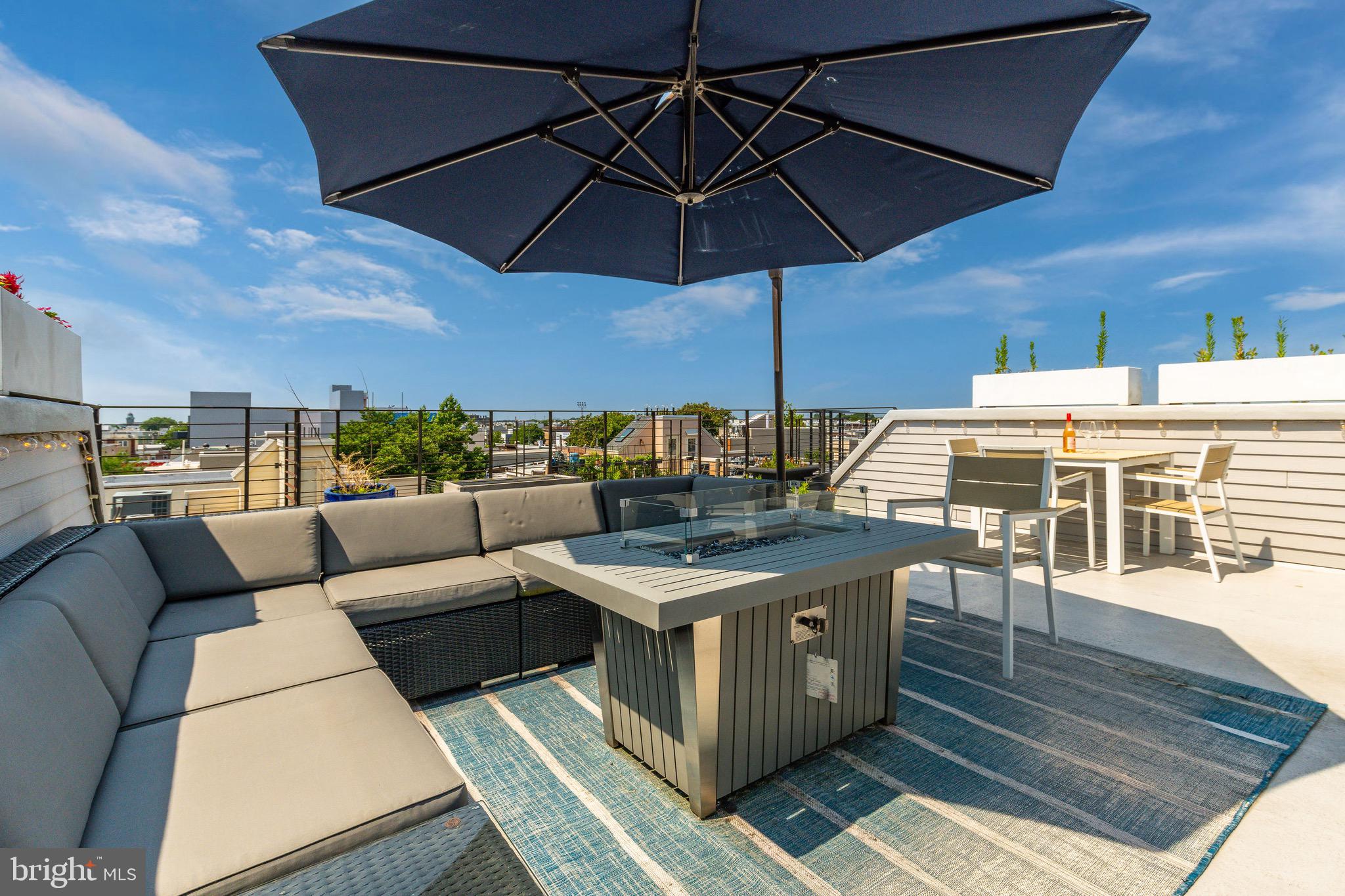 1733 Carpenter Street, Unit D Philadelphia, PA 19146 - Photo 32 of 37 a view of a rooftop deck with couch and chairs