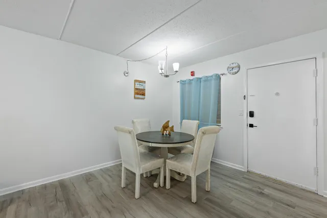 a dining room with furniture and wooden floor