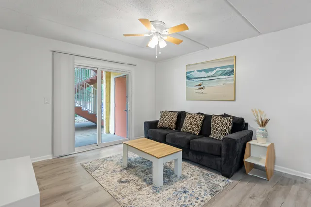 a living room with furniture and wooden floor