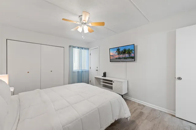 a bedroom with a large bed and a chandelier