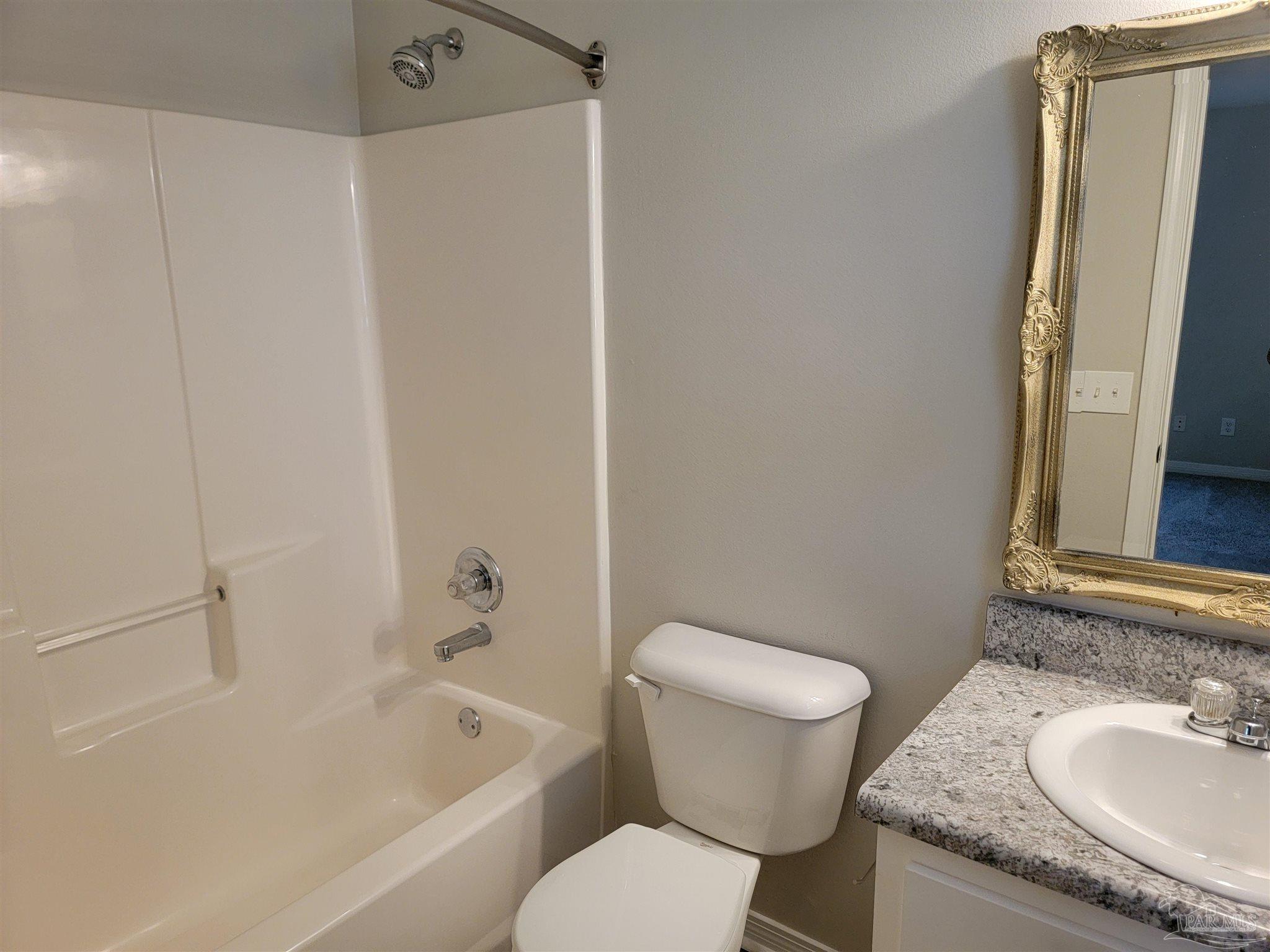 4878 Pineview Ridge Road Pace, FL 32571 - Photo 16 of 20 a bathroom with a granite countertop sink toilet and shower