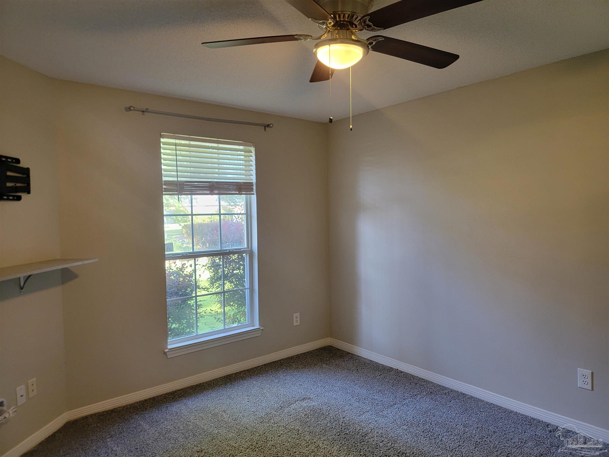 4878 Pineview Ridge Road Pace, FL 32571 - Photo 3 of 20 an empty room with a window and ceiling fan
