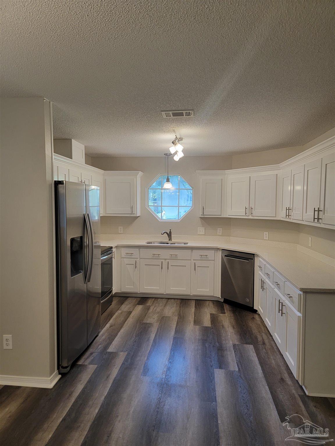 4878 Pineview Ridge Road Pace, FL 32571 - Photo 6 of 20 a kitchen with granite countertop a stove a sink and a refrigerator