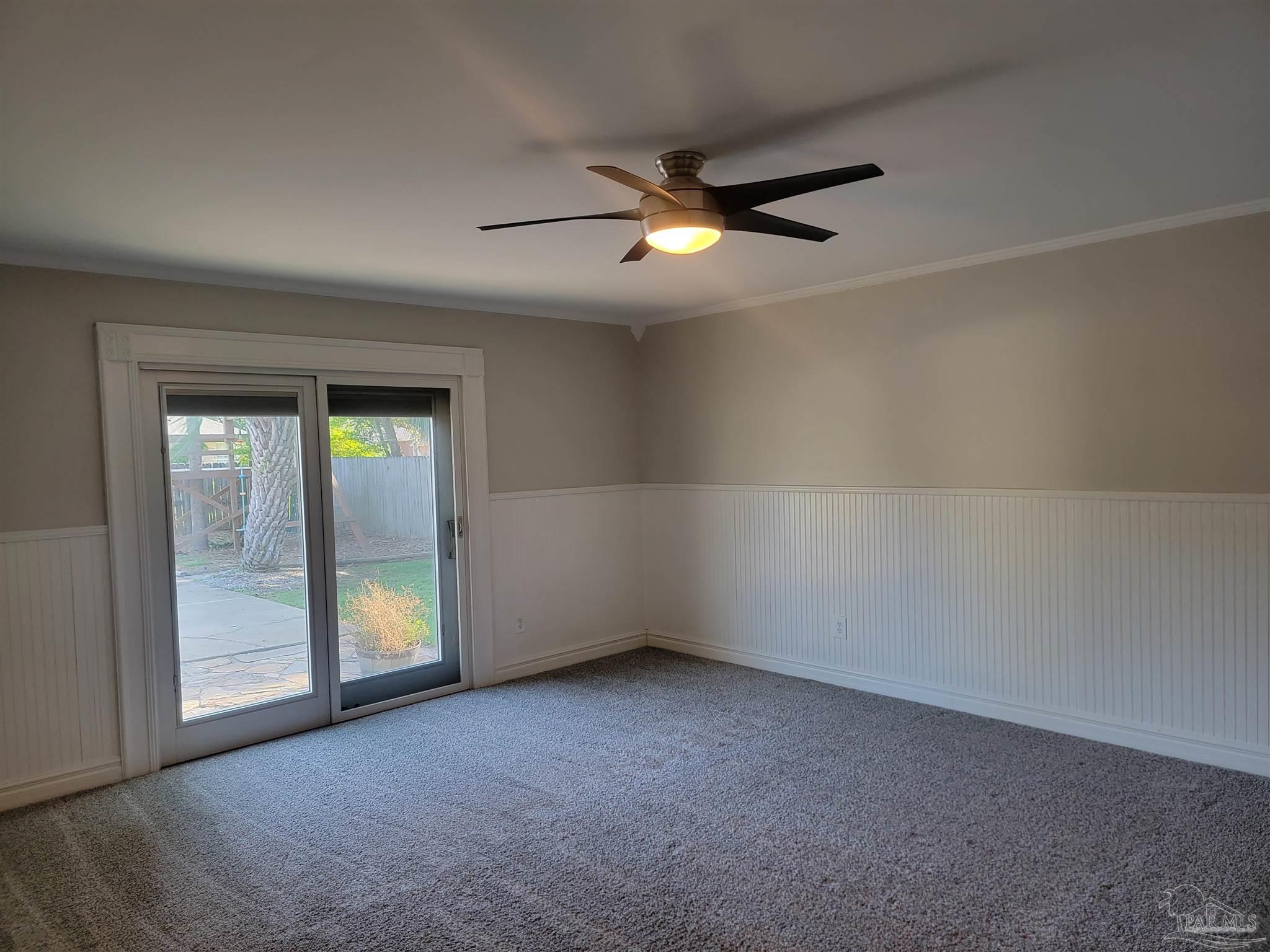4878 Pineview Ridge Road Pace, FL 32571 - Photo 7 of 20 an empty room with windows and fan