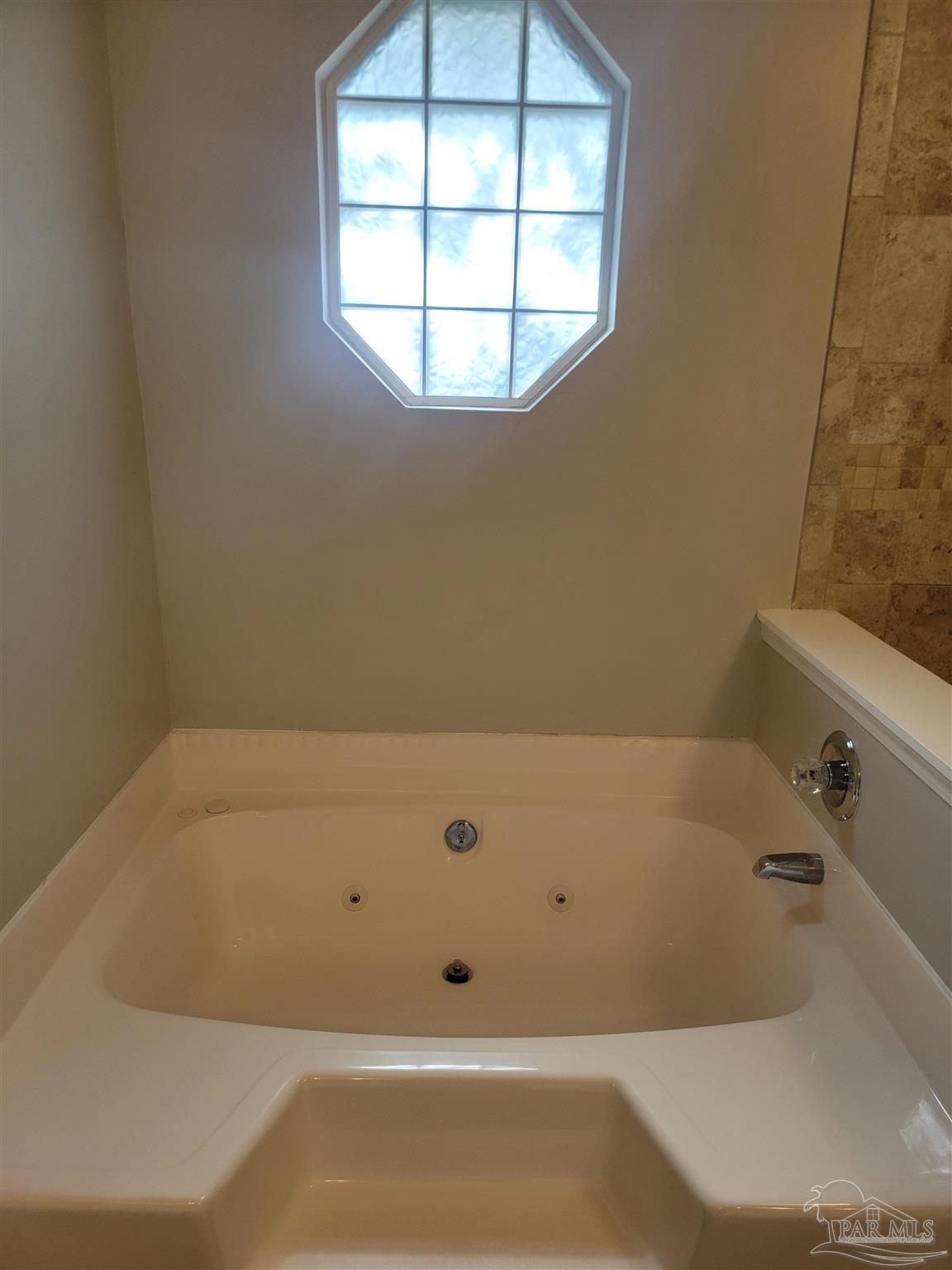 4878 Pineview Ridge Road Pace, FL 32571 - Photo 10 of 20 a bathroom with a bathtub