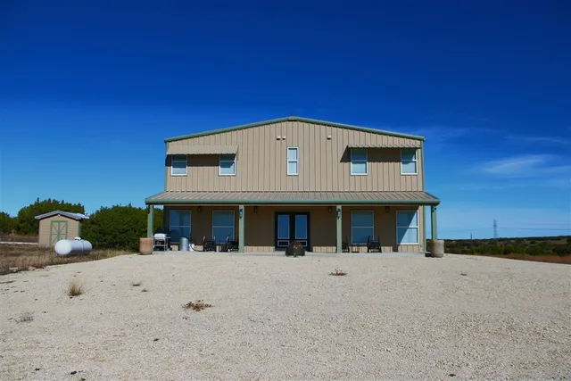 a front view of a house with large windows