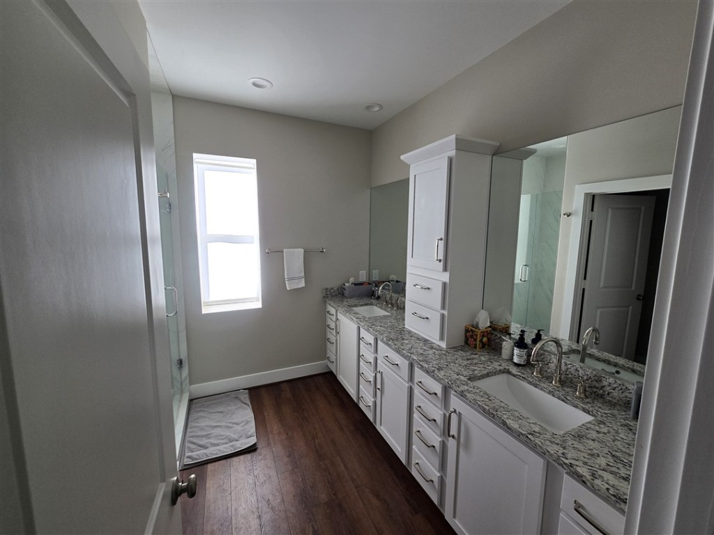 1684 County Road 2234 Lampasas, TX 76550 - Photo 24 of 35 a bathroom with granite countertop a sink and a large mirror