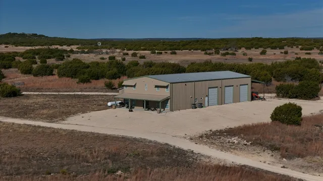 an aerial view of a house with a yard