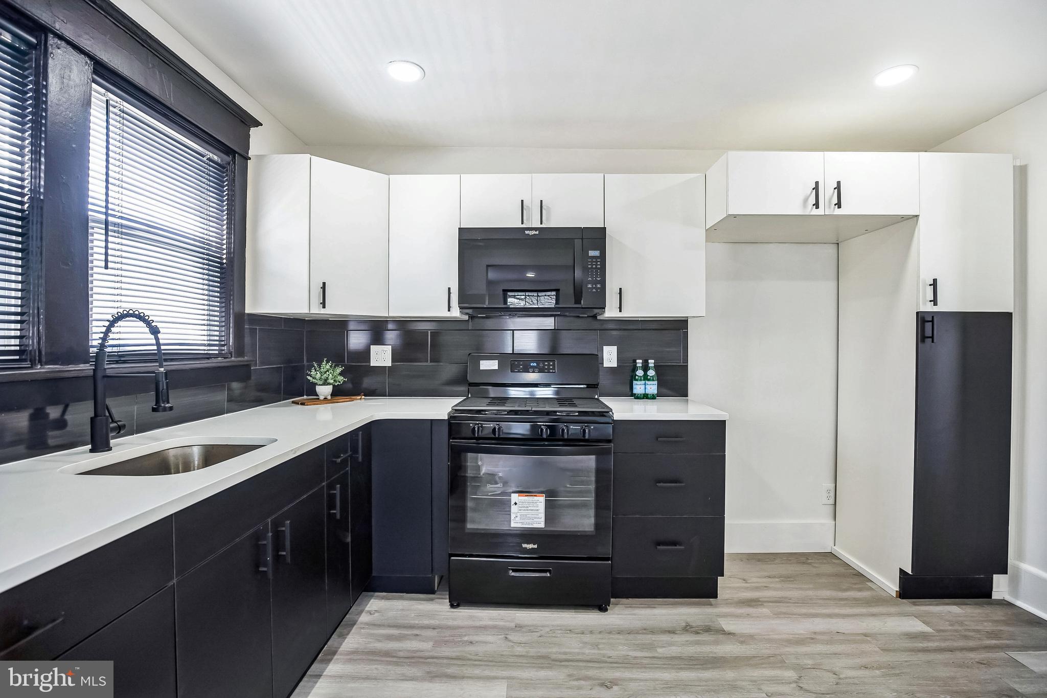 a kitchen with stainless steel appliances granite countertop a stove and a refrigerator