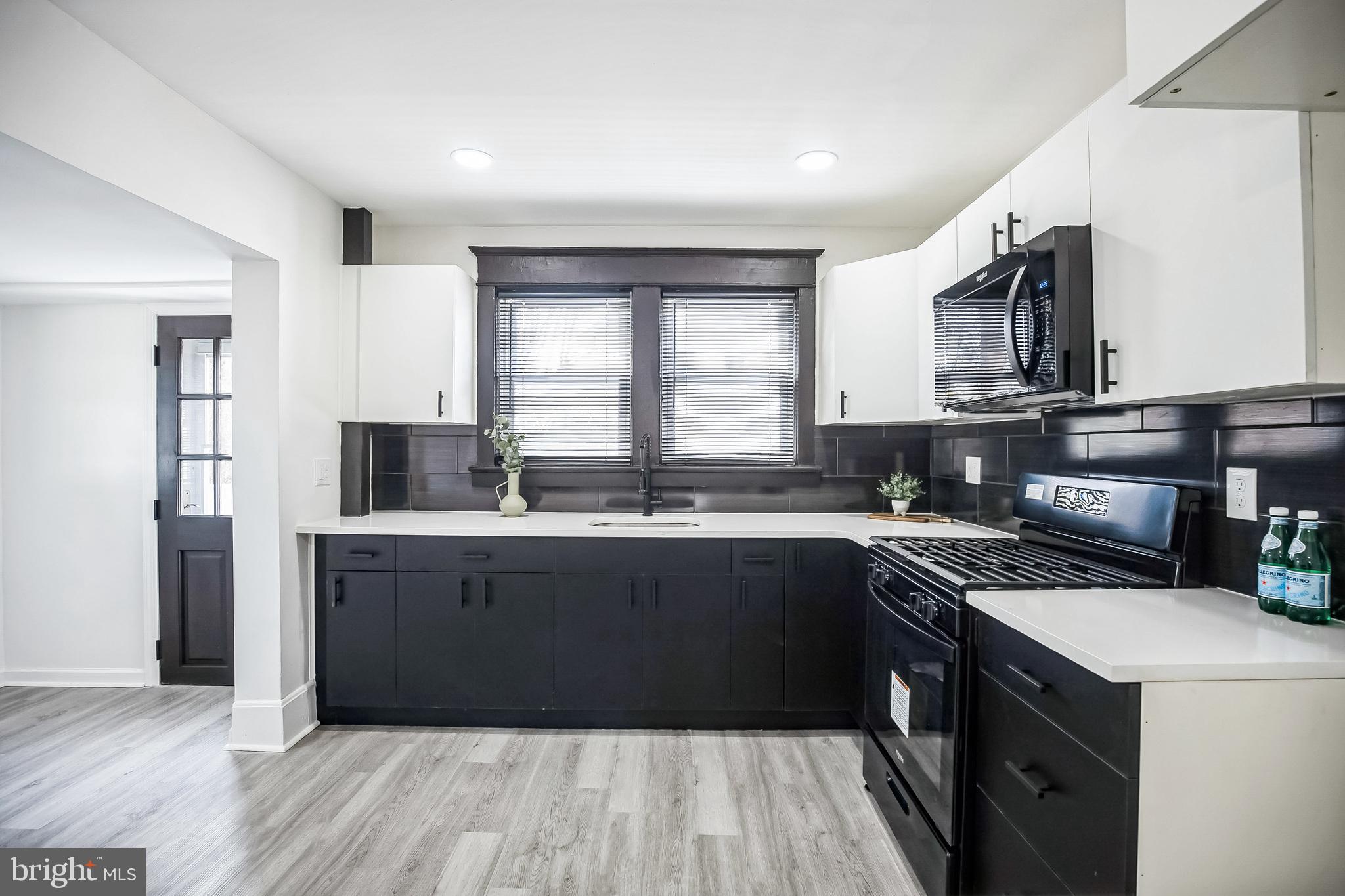 24 Cuthbert Road Cinnaminson, NJ 08077 - Photo 14 of 30 a kitchen with stainless steel appliances granite countertop a sink stove and refrigerator
