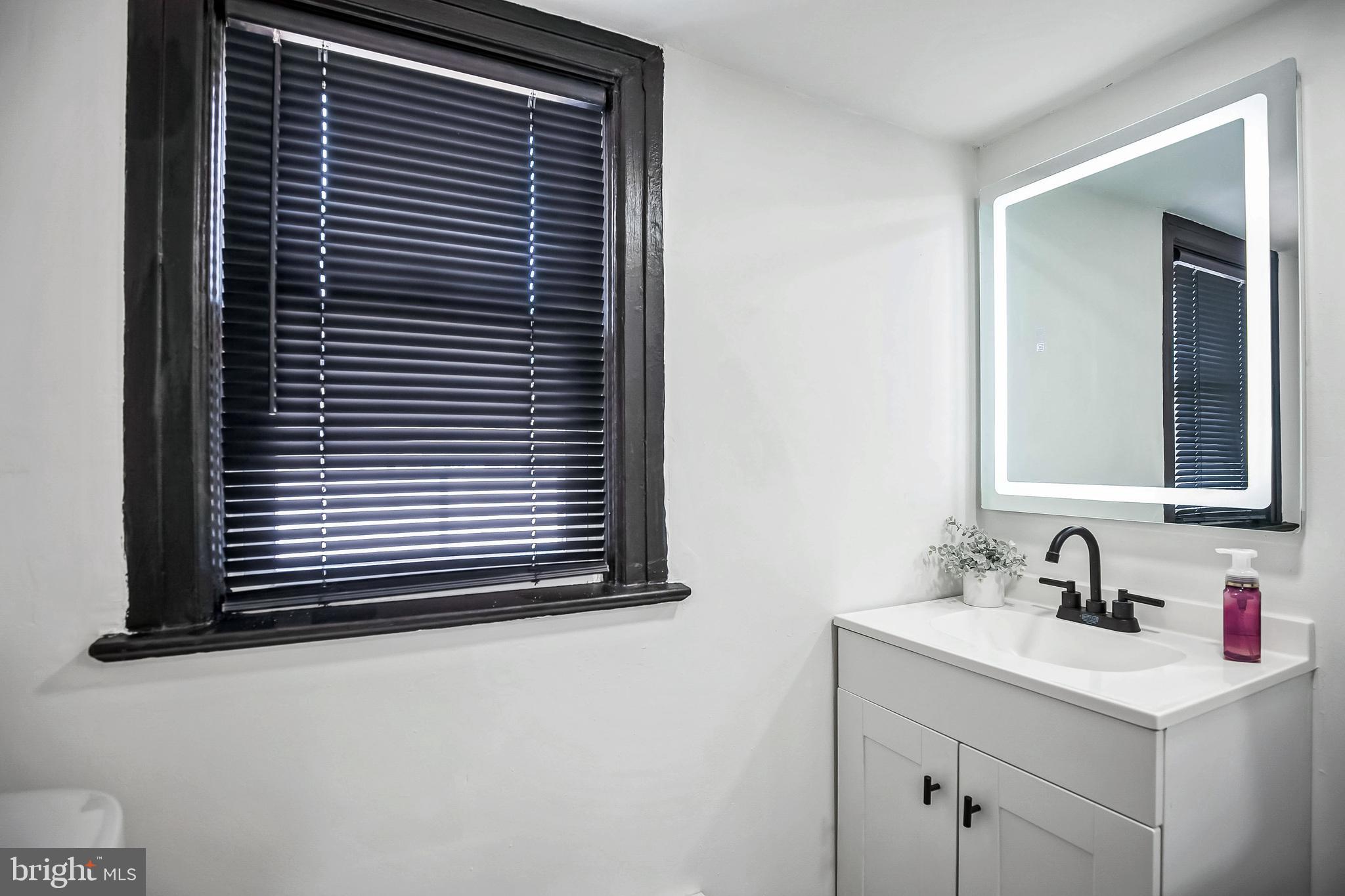 24 Cuthbert Road Cinnaminson, NJ 08077 - Photo 22 of 30 a bathroom with a sink and a mirror