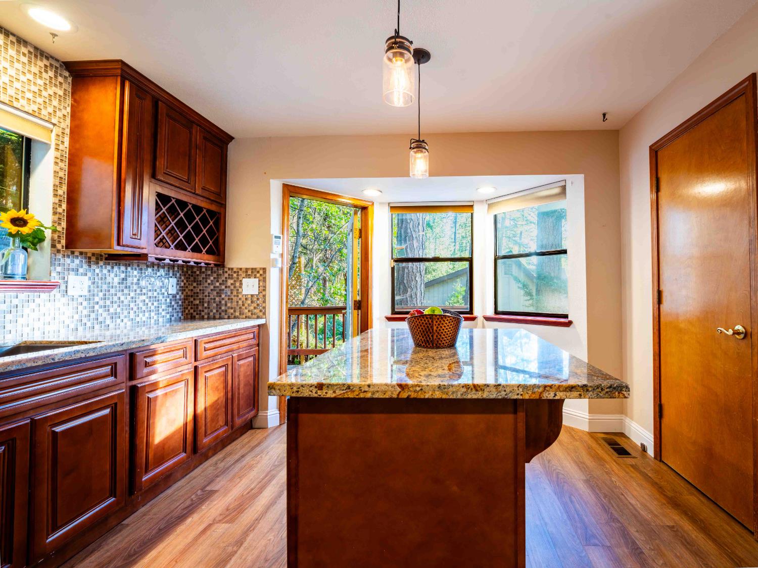 11419 Sunset Place Grass Valley, CA 95949 - Photo 11 of 47 a kitchen with stainless steel appliances granite countertop sink stove and wooden floor