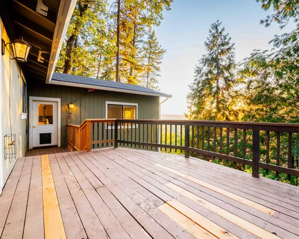 a view of a wooden deck and a yard