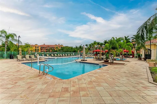 a view of a swimming pool and lounge chairs