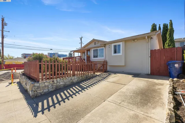 a view of a house with wooden deck front of house