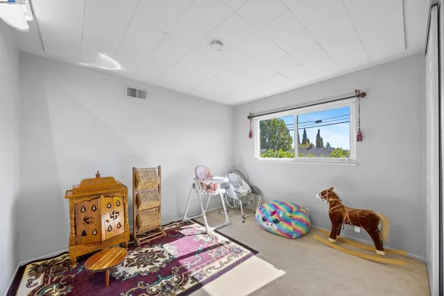 a bedroom with furniture and a window