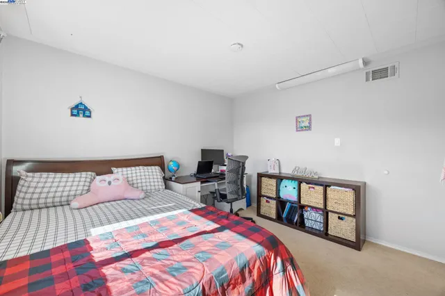 a bedroom with a bed and a book shelf