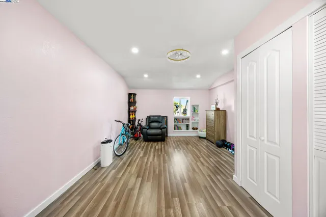 a view of a living room with furniture and wooden floor