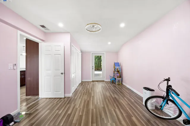 a view of empty room with wooden floor