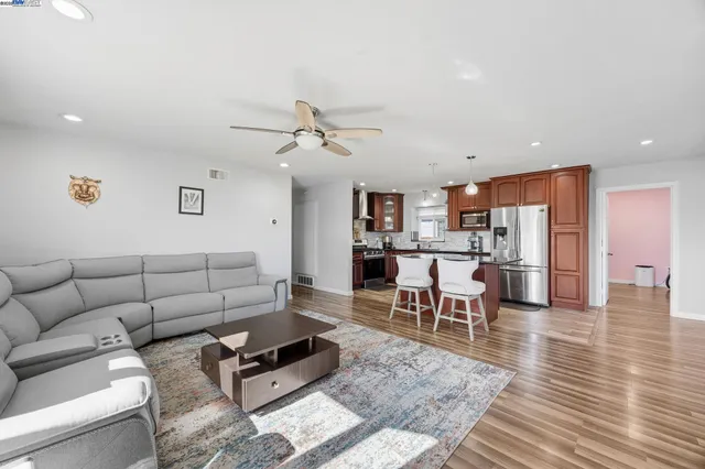 a living room with furniture and kitchen view