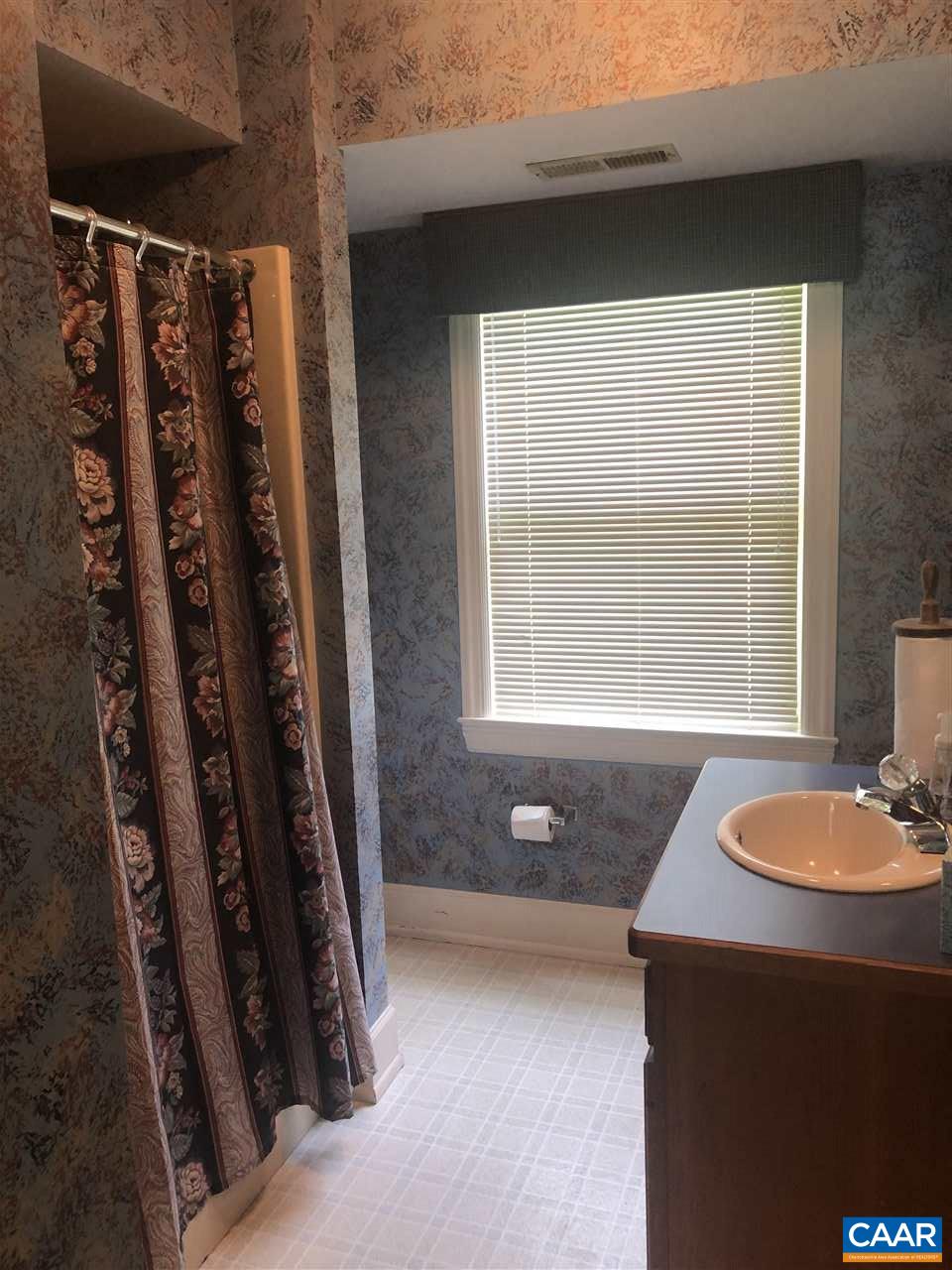 2771 Beech Grove Road Roseland, VA 22967 - Photo 13 of 31 a bathroom with a sink a toilet and tub